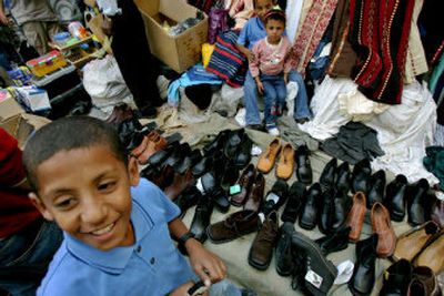 
Palestinian schoolchildren sell used shoes and clothes at a market in Ramallah on Saturday. 
 (Associated Press / The Spokesman-Review)
