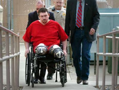 
Barry McAdoo, accused in the death of his toddler son, is wheeled into court Wednesday in Coeur d'Alene for his preliminary hearing. Both of McAdoo's lower legs were severely frostbitten and later amputated. 
 (Jesse Tinsley / The Spokesman-Review)