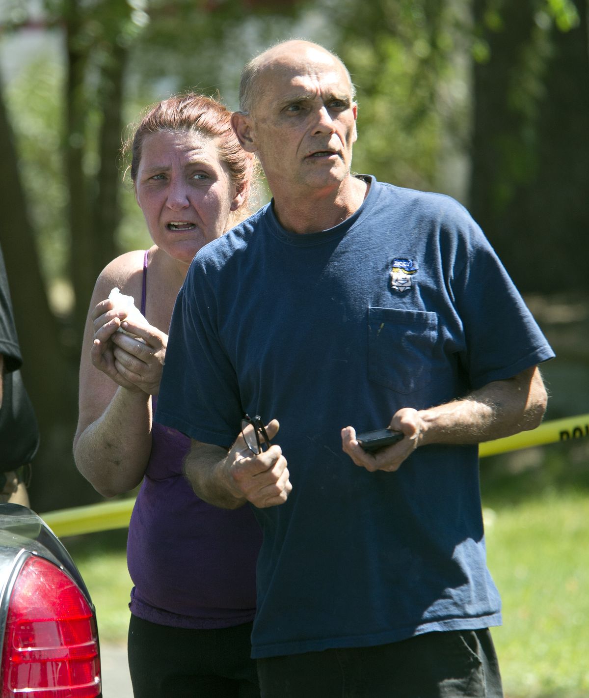 Jim Deno was on the scene to comfort an unidentified woman after Saturday’s shooting. Witnesses said the woman ran toward the house as gunfire erupted and was restrained by police. Police escorted the woman to a patrol car for questioning. (Dan Pelle)