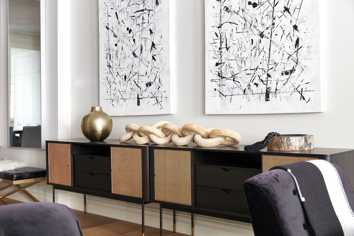 A blend of unique and unexpected accessories are paired together to help create a focal-point vignette on a long console.  (Scott Gabriel Morris/Tribune News Service)