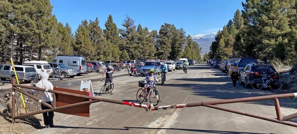 Vehicles crowd the Upper Mammoth Drive parking lot. The gate in the foreground marks the start of the vehicle-free cycling zone in spring.  (Brett French/Billings Gazette)