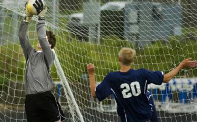 
Mead goalkeeper Jason Gass snares a shot as Bellarmine Prep's Elliott Morton watches in a State 4A quarterfinal soccer match Saturday.
 (Christopher Anderson / The Spokesman-Review)