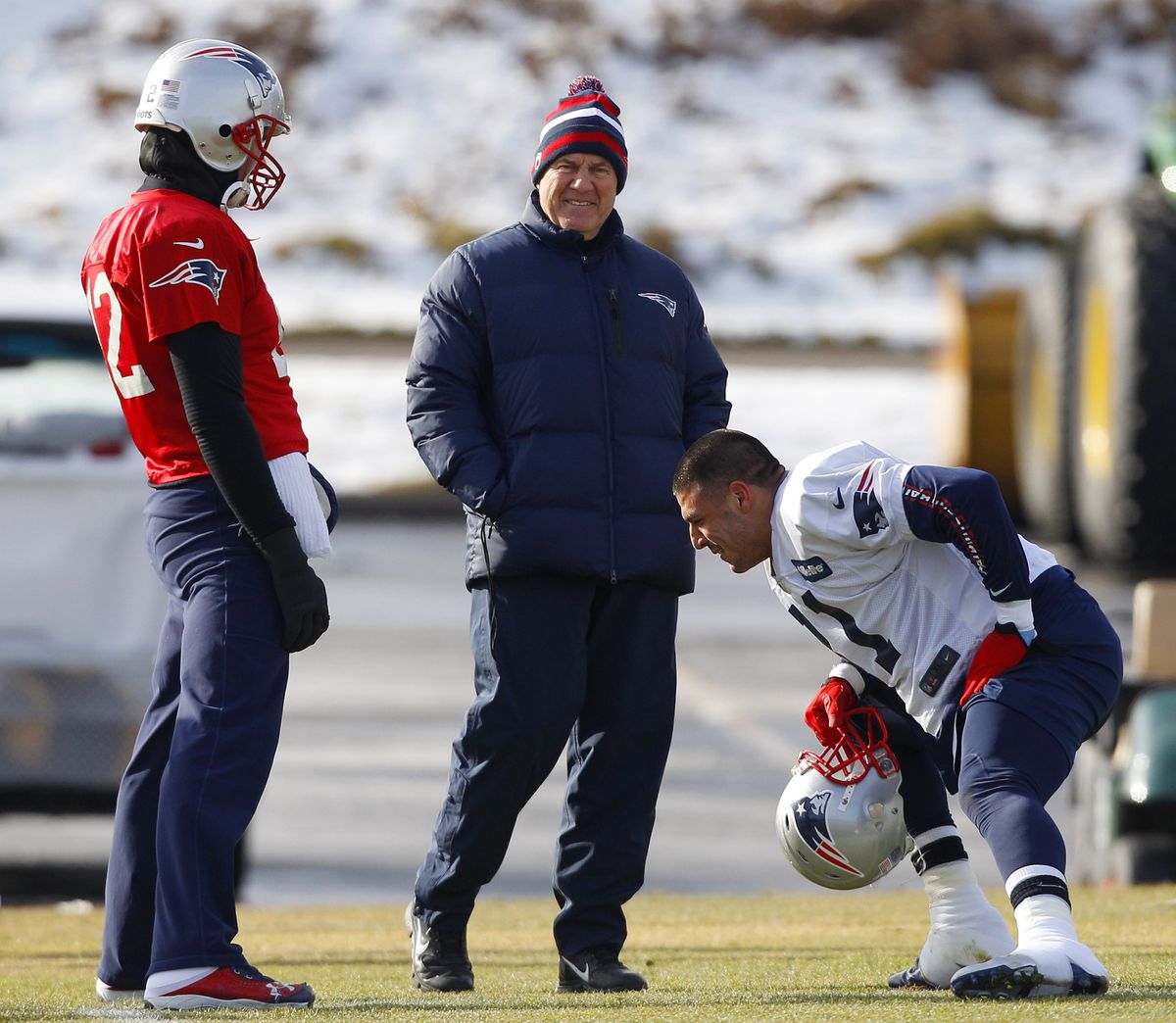 Patriots coach Bill Belichick smiles while talking with quarterback Tom Brady, left, and tight end Aaron Hernandez. (Associated Press)