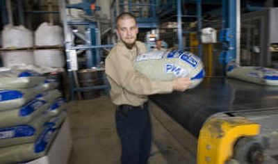 
Josh Hermann loads a bag of Pam-12 onto a pallet Thursday in Green Bay, Wis. The U.S. Forest Service is testing PAM-12 as a way to restore soil damaged by fire. Associated Press
 (Associated Press / The Spokesman-Review)