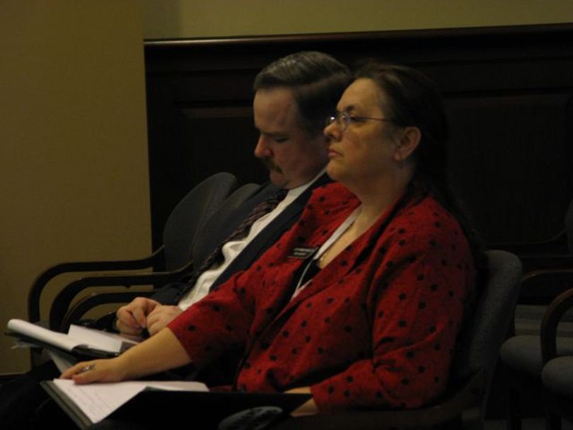 Idaho Rep. Shannon McMillan, right, and her son James, left, listen Tuesday as an Idaho House committee debates their resolution ordering the EPA to leave the Coeur d'Alene Basin within five years and take its Superfund cleanup with it. (Betsy Russell)