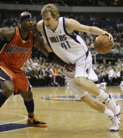 
Dallas' Dirk Nowitzki, right, drives around Golden State's Al Harrington in his return from a four-game absence.Associated Press
 (Associated Press / The Spokesman-Review)