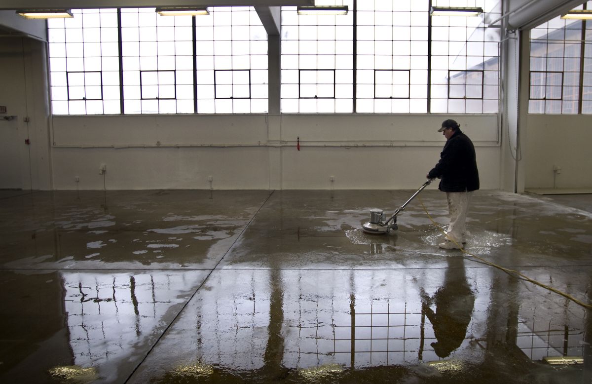 Brad Swerin removes old paint in what will be Cascade Aerospace USA’s new Spokane International Airport facility. The British Columbia company specializes in heavy aircraft maintenance.   (Photos by Colin Mulvany / The Spokesman-Review)