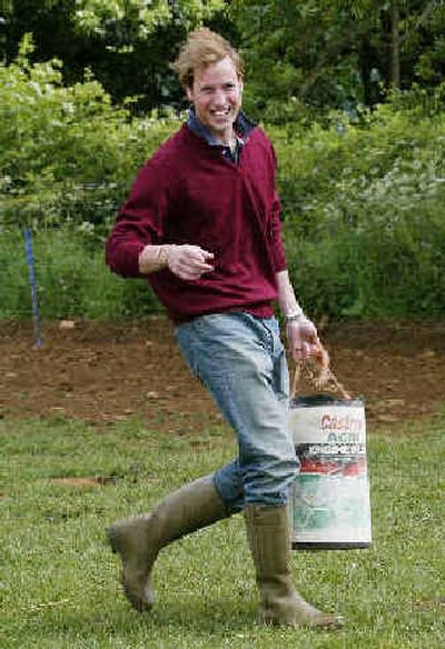 
 Prince William carries pig food at Home Farm near Tetbury, Gloucester, west of England, on Saturday.  Prince William carries pig food at Home Farm near Tetbury, Gloucester, west of England, on Saturday. 
 (Associated PressAssociated Press / The Spokesman-Review)