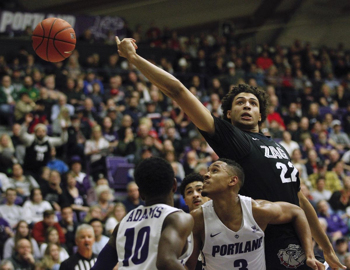 Gonzaga forward Anton Watson, right reaches for a rebound over Portland guards Chase Adams and Isaiah White during the second half of an NCAA college basketball game in Portland, Ore., Thursday, Jan. 2, 2020. (Steve Dipaola / AP)