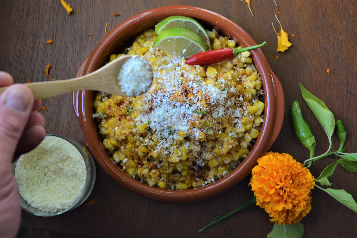 This recipe for esquites, or toasted corn, uses fresh summer corn for a salad that also includes cheese, chilies and lime.  (Ricky Webster/For The Spokesman-Review)