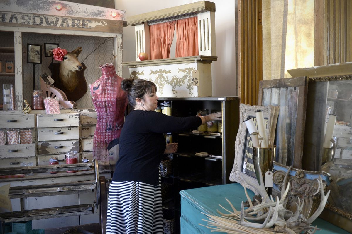 Holly Baublitz arranges items in Lucky Detour, an antiques/shabby chic/collectibles store she opened with Celeste Shaw on Inland Empire Way in Vinegar Flats, the semi-rural neighborhood south of downtown which is getting a shot in the arm from this and other business ventures. (Jesse Tinsley)
