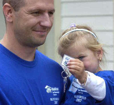 
Edina Arnautovic holds the key given to her father, Omer, for their new home during Habitat for Humanity's Blitz Build celebration  Saturday. 
 (Dan Pelle / The Spokesman-Review)