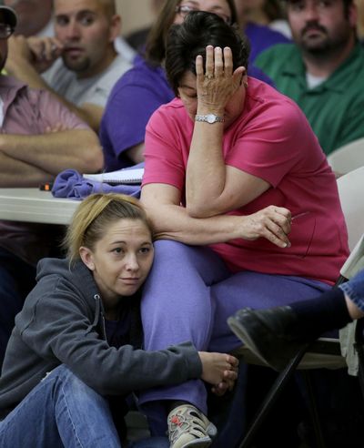 Jeanette Sulak and her daughter Jill Sulak-Vrla listen during a town hall meeting Saturday, three days after an explosion at a fertilizer plant. (Associated Press)