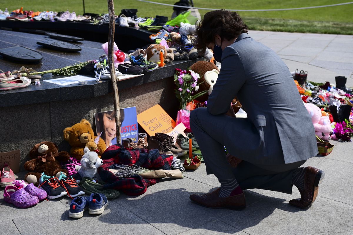 In this June 1, 2021 photo, Canadian Prime Minister Justin Trudeau visits a memorial at the Eternal Flame on Parliament Hill in Ottawa that