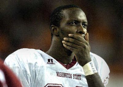 
An injured Jason Hill watches the Cougs run out the clock. 
 (Christopher Anderson / The Spokesman-Review)