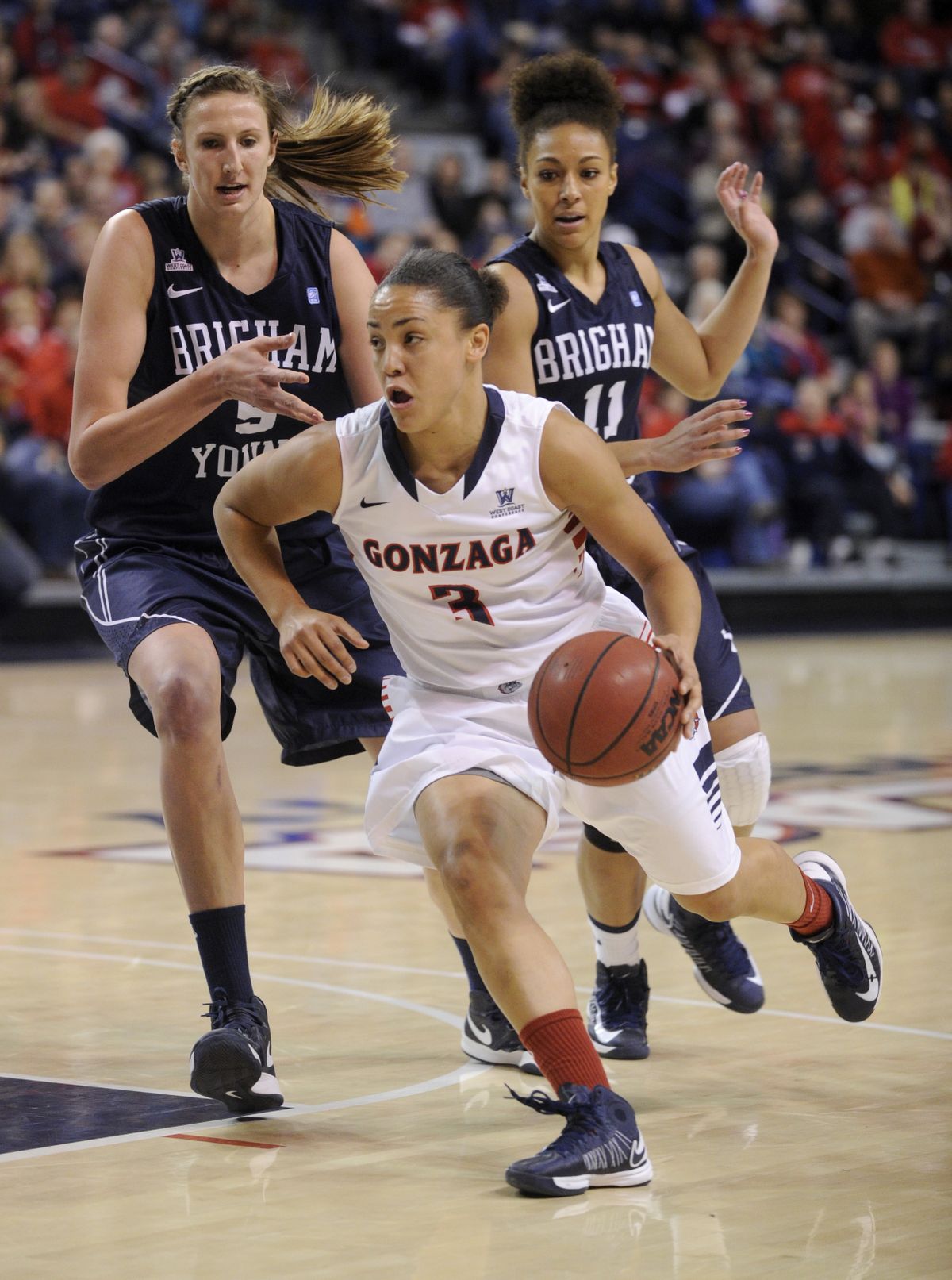 Haiden Palmer drives, followed by BYU’s Jennifer Hamson (5) and Xojian Harry. Palmer had 11 points. (Colin Mulvany)