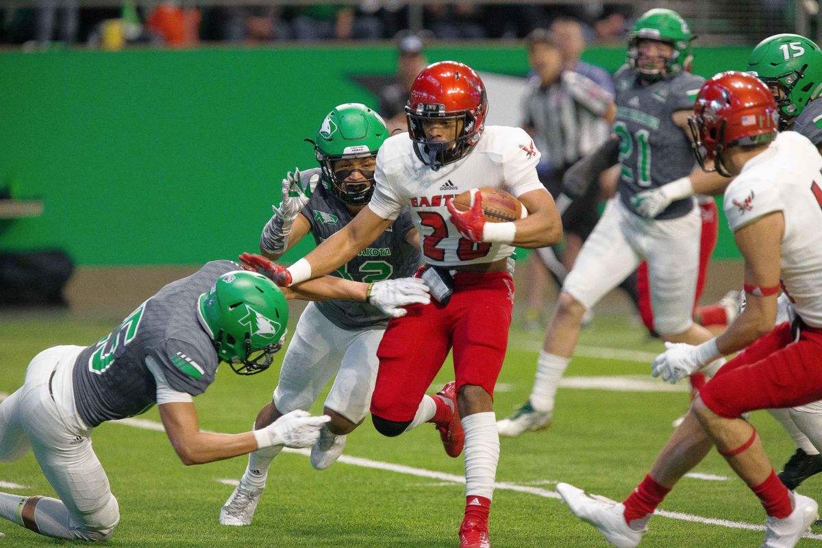 Eastern Washington running back Antoine Custer Jr. (28) evades North Dakota defenders during Saturday