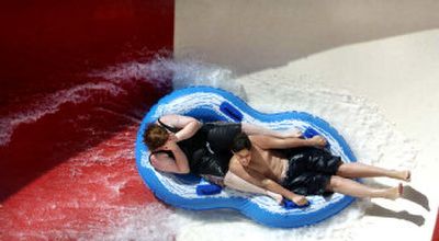 
Bryanne Raschko, 15, left, covers her face while Sheldon Soreano, 13, hangs on while navigating  the new Cannon Bowl ride at Splash-Down Water Park on Monday afternoon. 
 (Holly Pickett / The Spokesman-Review)