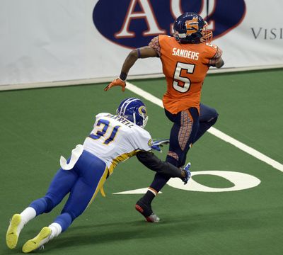 Terrance Sanders of the Spokane Shock takes a kickoff and scampers out of the grasp of Tampa Bay's James Harrell for a touchdown Monday at the Spokane Arena. The Shock beat the Storm, 55-52. (Jesse Tinsley)