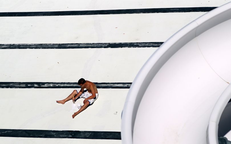 In this Tuesday May, 4, 2010 photo, Brad Brush uses a paint bush to touch up the 50 meter pool at the Aquatic Center prior to filling in St. Joseph. Mo. (Eric Keith / St. Joseph News-press)