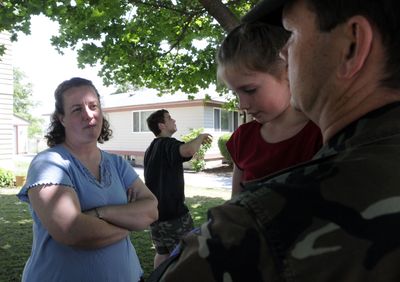 Chris VanAusdal, left, talks with her husband, Ron, holding their daughter Sara, 3, at their home at Fairchild Air Force Base on Tuesday.   Richard, 17, center,  just graduated from high school. With six kids, the VanAusdal family has experienced tough transitions between bases and schools.  A proposed compact would standardize education for children from military families.   (Jesse Tinsley / The Spokesman-Review)