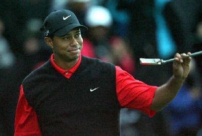 Tiger Woods waves to the crowd after winning the American Express Golf Championship in England.
(Associated Press / The Spokesman-Review)