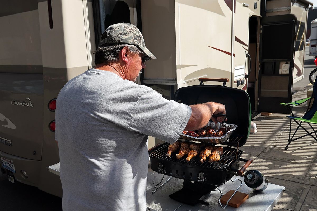 
Bob Hill of Camano Island grills chicken along Utah Avenue south of CenturyLink Field prior to the Seahawks-Raiders game on Aug. 28 in Seattle.
 (John Nelson)