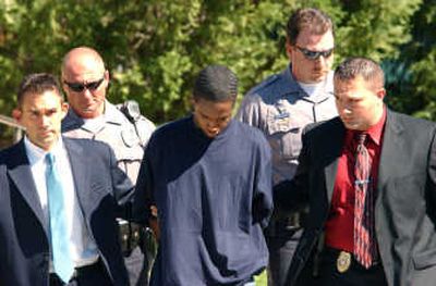 
Loyer D. Braden, left, a suspect in Friday's shooting of two Delaware State University students, is escorted from the Dover, Del., police station to court Monday. Associated Press
 (Associated Press / The Spokesman-Review)