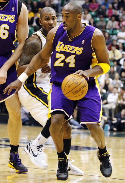 Jazz guard Raja Bell couldn’t stop Lakers guard Kobe Bryant, right, from scoring 40 points. With the overtime victory, Los Angeles won its fourth game in a row over a Western Conference foe. (Associated Press)
