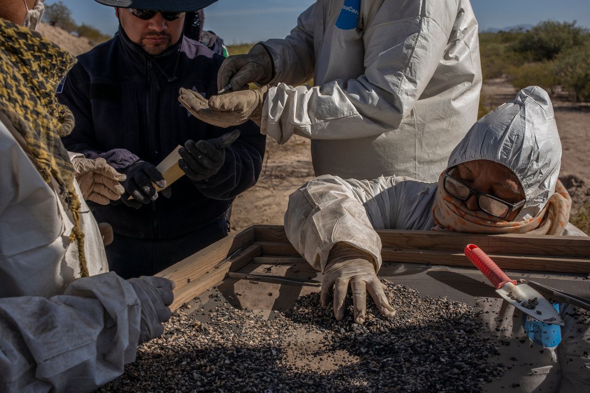 Volunteers in 2019 separate crushed and burned human bones from rocks and dirt in Torreón, Mexico, as part of an national effort to discover what has happened to disappeared people. MUST CREDIT: Photo for The Washington Post by Alejandro Cegarra.  (Alejandro Cegarra/For The Washington Post)