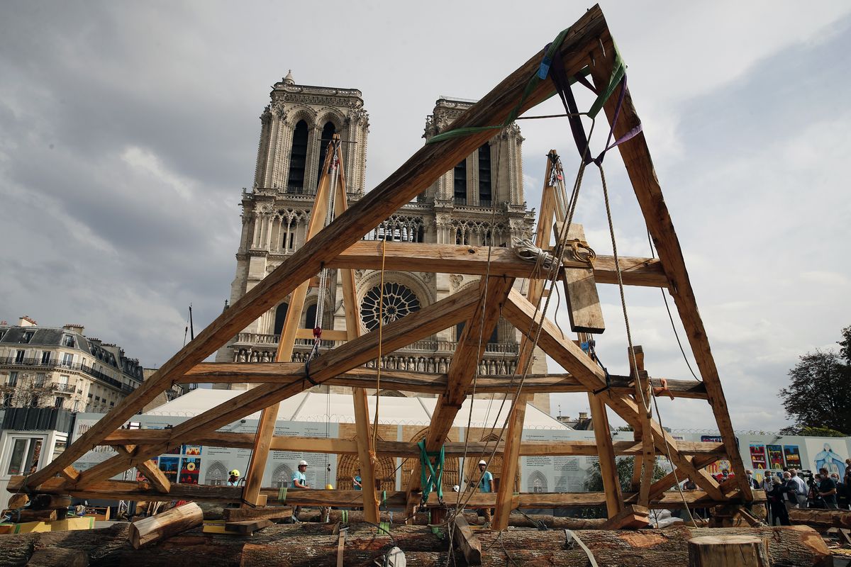 Carpenters put the skills of their Medieval colleagues on show on the plaza in front of Notre Dame Cathedral in Paris, France, Saturday, Sept. 19, 2020, the day honoring European heritage, by reproducing for the public a section of the elaborate carpentry used when the edifice was built. The elaborate wooden beams went up in flames in a devastating April 2019 fire that also toppled the spire of the cathedral, now being renovated.  (Francois Mori)