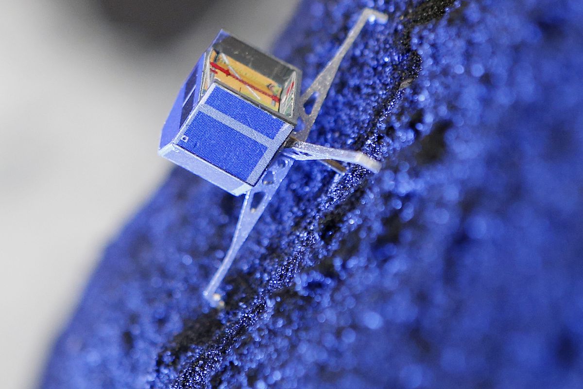 A model of Rosetta lander Philae stands on a model of comet 67P/Churyumov-Gerasimenko, at the European Space Agency ESA in Darmstadt, Germany, Wednesday, Nov.12, 2014. Europe's Rosetta space probe was launched in 2004 with the aim of studying the comet and learning more about one of the biggest questions about the origin of the universe. (Michael Probst / Associated Press)