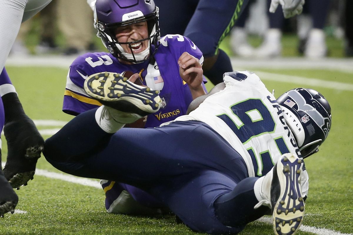 Minnesota Vikings quarterback Trevor Siemian is sacked by Seattle Seahawks defensive end Branden Jackson  during the second half of Friday’s NFL preseason game in Minneapolis. (Bruce Kluckhohn / AP)