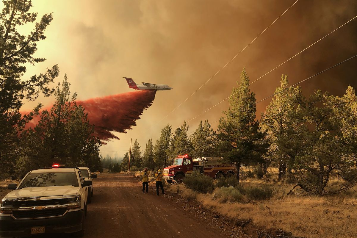 This photo provided by the Oregon Department of Forestry shows a firefighting tanker making a retardant drop over the Grandview Fire near Sisters, Ore., Sunday, July 11, 2021. The wildfire doubled in size to 6.2 square miles (16 square kilometers) Monday, forcing evacuations in the area, while the state