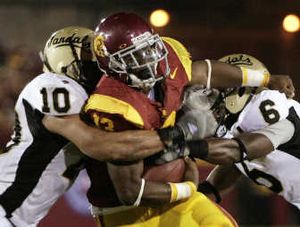 
Idaho Vandals Shiloh Keo, left, and Stanley Franks team up to tackle Southern Cal's Stafon Johnson during a season opener. Associated Press
 (Associated Press / The Spokesman-Review)
