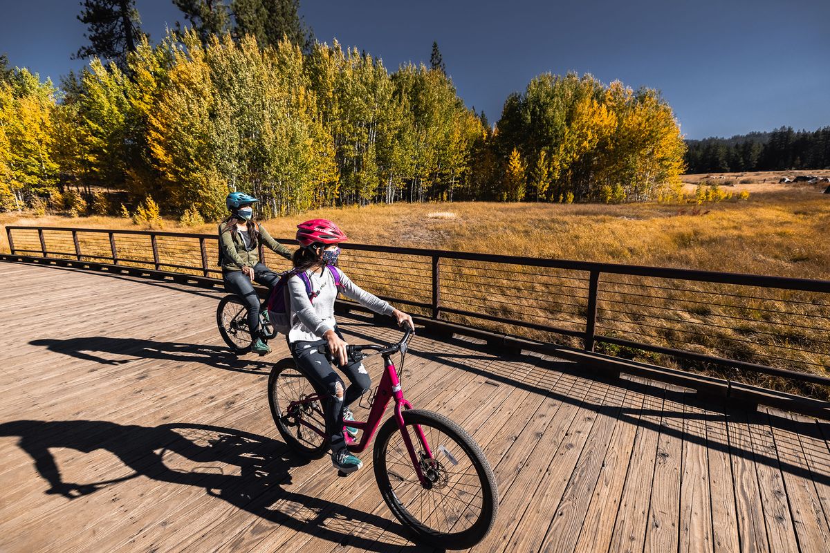 Tourists ride along the 2.8-mile Lam Watah Nature Trail at Lake Tahoe near Stateline, Nevada. Many travelers have been focused on outdoor pursuits this year.  (Brian Walker)