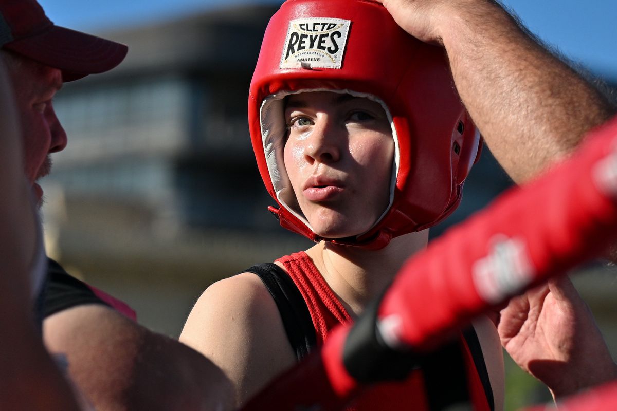 Spokane Boxing’s Ruby Lannigan chats with Rick Welliver, left, as she prepares to face Lights Out Boxing’s Gloria Diaz during Brick West Boxing hosted by Spokane Boxing on Saturday, July 9, 2022, at Brick West Brewery in Spokane, Wash.  (Tyler Tjomsland/The Spokesman-Review)