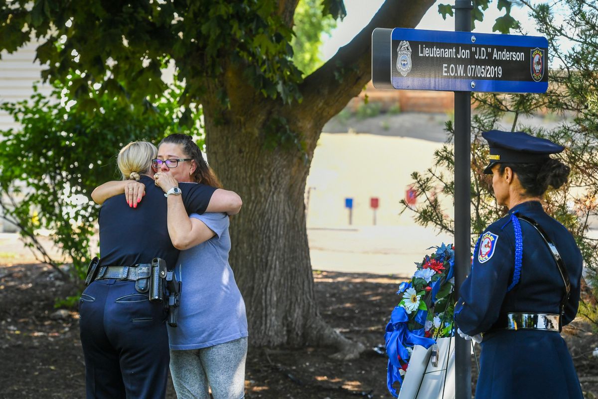 Michelle Anderson receives a comfort from Spokane police Capt. Tracie Meidl, left, during a memorial sign dedication for Spokane Police Lt. Jon Anderson on Tuesday, at the Spokane Police Academy.  (Dan Pelle/The Spokesman-Review)