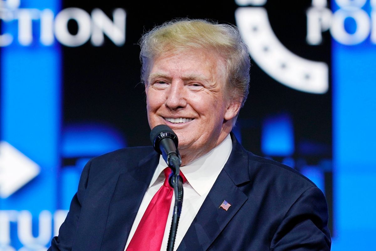 FILE - Former President Donald Trump smiles as he pauses while speaking to supporters at a Turning Point Action gathering in Phoenix, July 24, 2021. Trump is slamming politicians who refuse to say whether they’ve received COVID-19 booster shots, calling them “gutless.” In an interview with One America News Network on Tuesday night, he said unnamed politicians have been afraid to admit they got the booster shot.  (Ross D. Franklin)