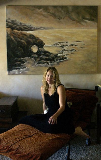 
Liberty Lake artist Natalie Gauvin sits on a chair she made in front of one of her paintings in her Liberty Lake home. 
 (LIZ KISHIMOTO Photo / The Spokesman-Review)