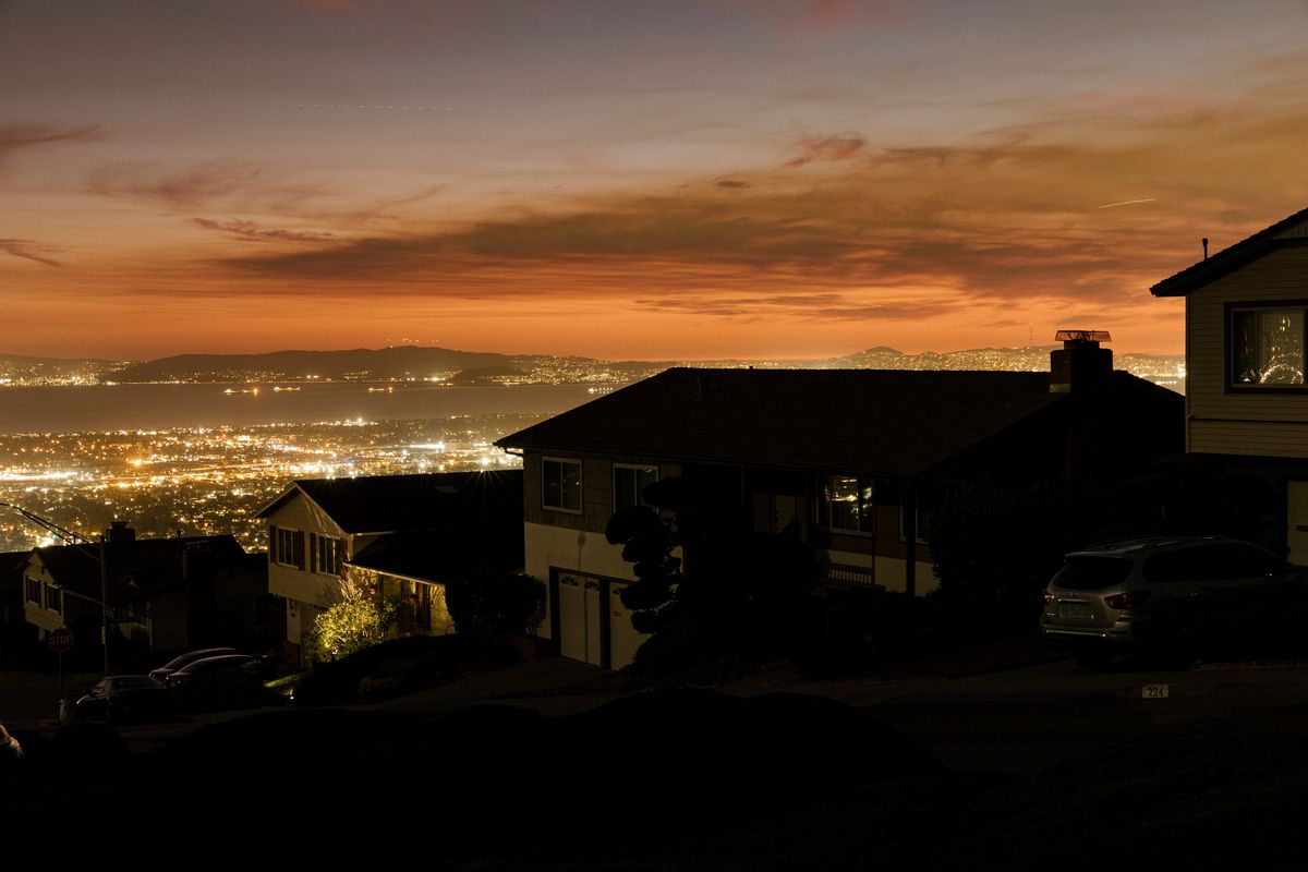 Houses sit without power during an outage in part of Oakland, Calif., in October 2019. California and the 34 other states that have deregulated all or parts of their electricity system tend to have higher rates than the rest of the country.  (New York Times)