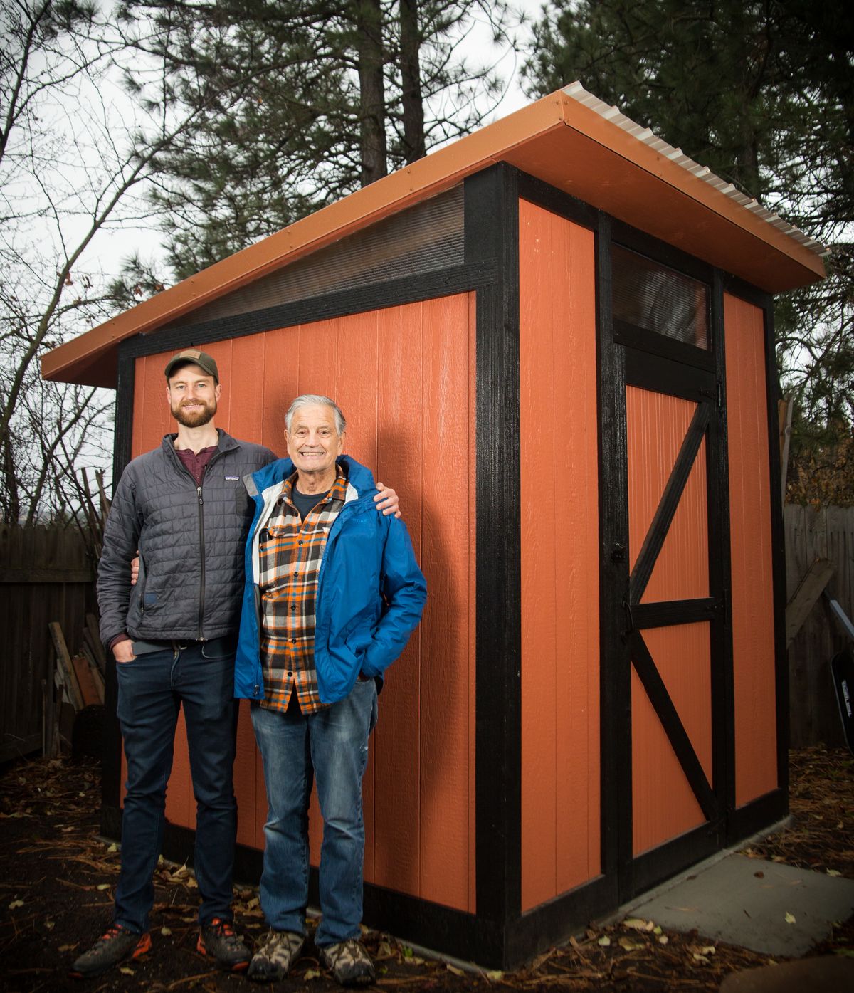 Chase Watson, left, and Rex Watson stand in front of their custom-built shed, just one part of their pandemic project at Rex’s house in Hangman Hills on Nov. 18. The father-and-son team also built a deck this summer, but the shed came first, built from the ground up during May and June. It was a learning experience for the Watsons, from pouring concrete to installing the windows. (Libby Kamrowski/ THE SPOKESMAN-REVIEW)