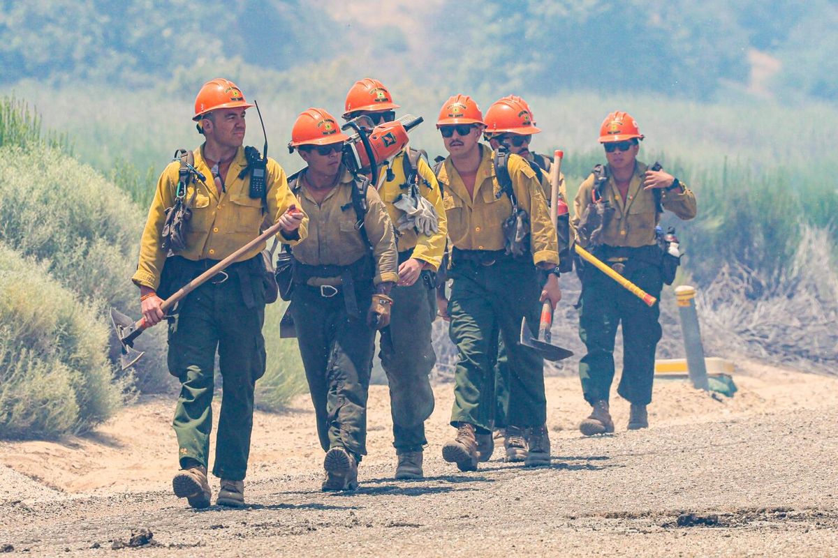 Crew members of the Little Tujunga Hot Shots hike to positions along Hard Luck Road to observe a burnout operation as the Post fire continues to grow north of Pyramid Lake just west of Interstate 5 in California.  (Robert Gauthier/Los Angeles Times/TNS)