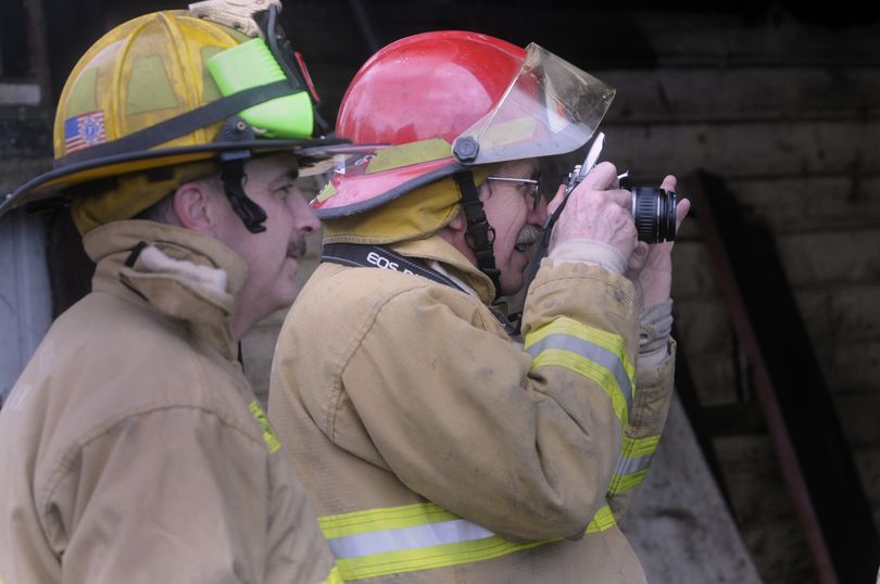 Inspector Greg Bennett and Assistant fire marshal and investigator Paul Chase, right,   investigate a fire in a chicken coop in the 4000 block of North Willow Road. (J. BART RAYNIAK)