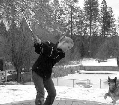 
Sierra Bezdicek, 11, a student at Midway Elementary, practices her 50- yard wedge shot over the frozen pond and apple tree before catching the morning bus to school. 
 (PHOTO COURTESY RANDY BEZDICEK / The Spokesman-Review)