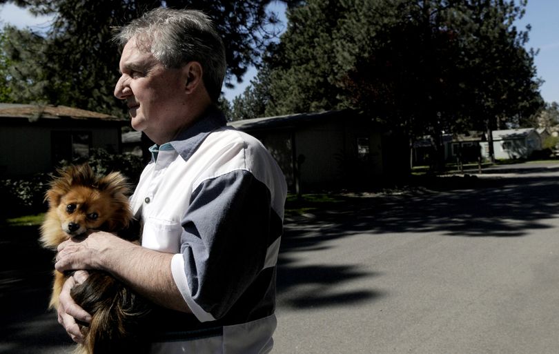 Wade Williams holds his dog Grizzly, near his home Coeur d'Alene on Thursday, May 13, 2010. He rescued Grizzly on Tuesday, May 11, 2010 from a coyote. (Kathy Plonka)