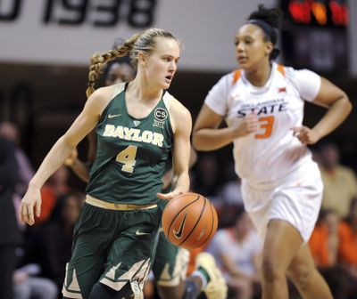 Baylor guard Kristy Wallace (4) glances behind her to watch Oklahoma State forward Mandy Coleman (3) come down court during the second half of a NCAA college basketball game in Stillwater, Okla., Tuesday, Feb. 13, 2018. Wallace scored 14 points in the 87-45 win over Oklahoma State. (Brody Schmidt / Associated Press)