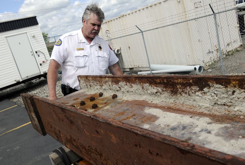 Spokane Valley Fire Marshall Kevin Miller looks at a 1,300-pound steel girder that was recovered from one of the towers at the World Trade Center. (J. Bart Rayniak)