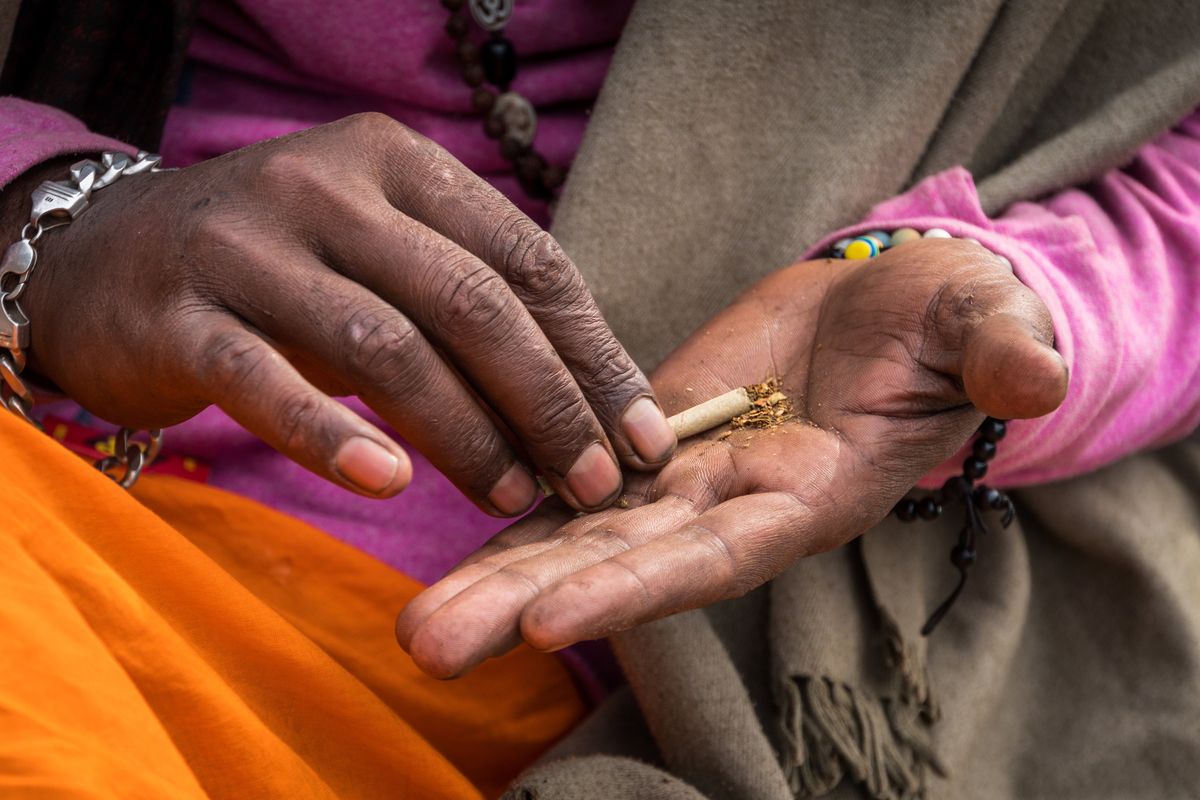 A Guru makes a smoking mixture, combining tobacco and hemp.  (Getty Images)