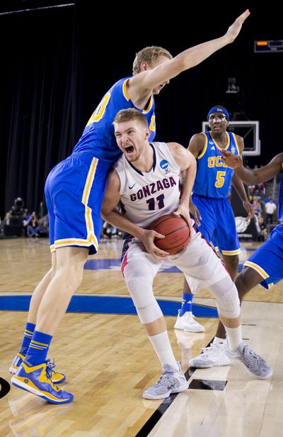 Gonzaga forward Domantas Sabonis (11) drives into the key as UCLA center Thomas Welsh defends during the second half of an NCAA Sweet Sixteen tournament last season in Houston. The two teams meet again on Saturday at the McCarthey Athletic Center. (Colin Mulvany / The Spokesman-Review)